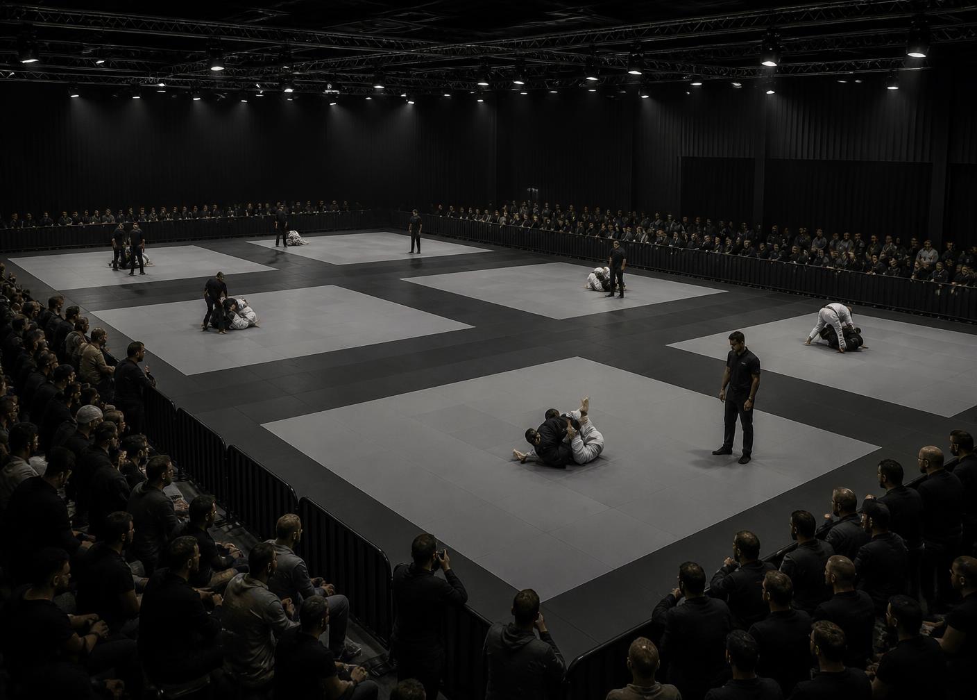 Multiple martial arts competition mat areas in use at a UK tournament